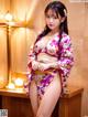 A woman in a kimono posing for a picture.