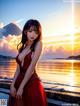 A woman in a red dress standing on a pier by the water.