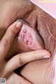 A close up of a man's penis with a pink hat on.