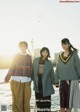 A group of three young women standing next to each other.